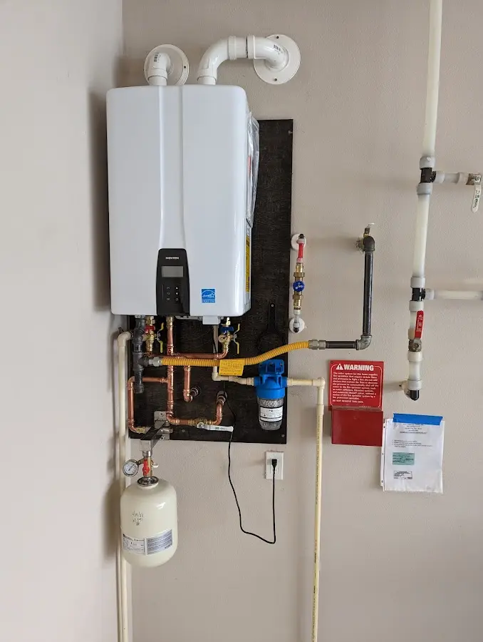 Professional plumber installing copper piping in a Brigham City home